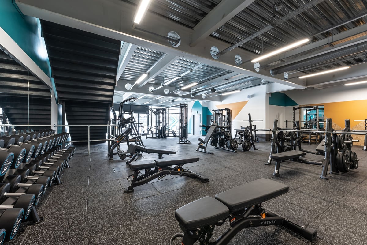 PureGym Yate: Weightlifting area with benches, free weights, weight machines, and rubberised flooring.