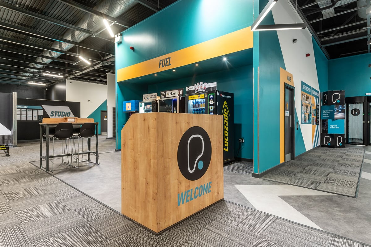 PureGym Southampton Bitterne: Fuel bar, welcome desk, studio space with rubber flooring.