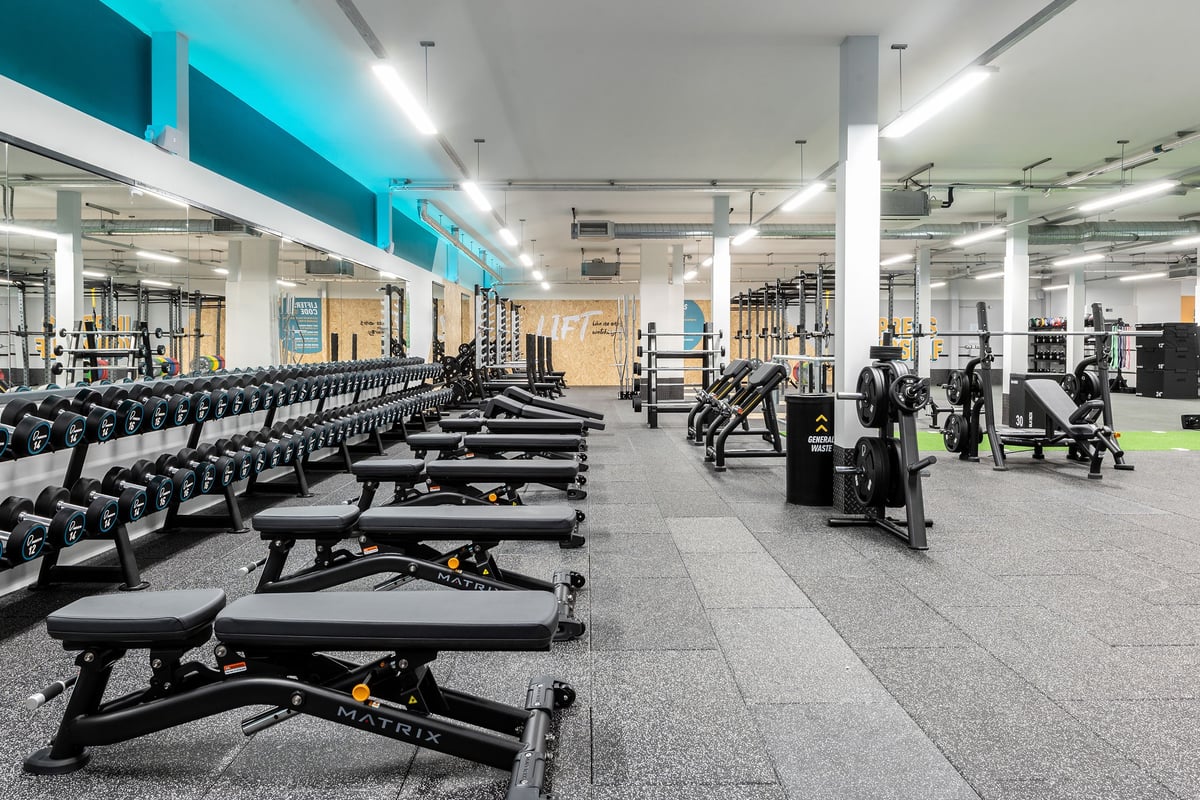 PureGym Milton Keynes Kingston Centre: Rows of weight benches, dumbbell racks, resistance machines, and rubberized flooring.