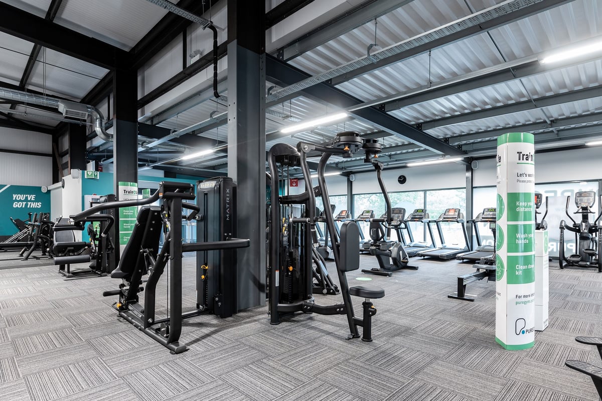 PureGym Kirkcaldy: Weight machines, resistance equipment, cardio machines, and rubberised flooring in a gym area.