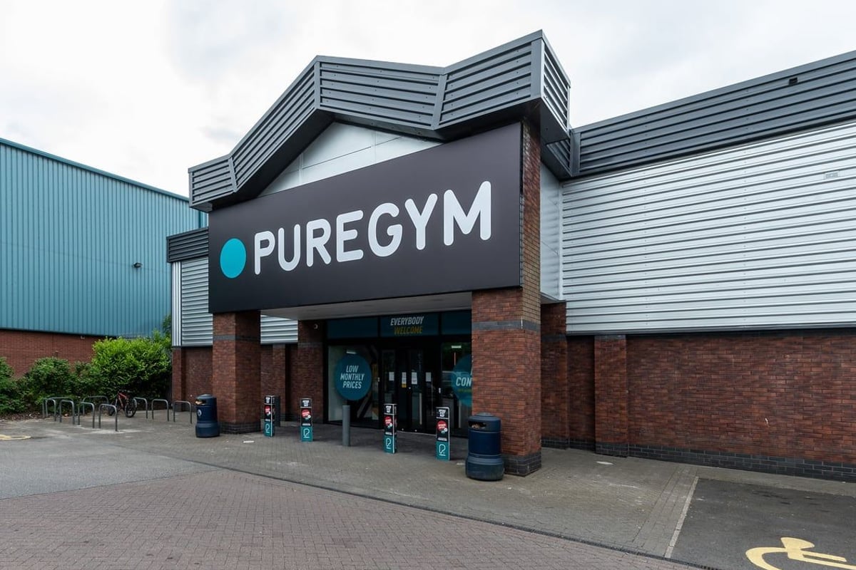 PureGym Macclesfield Silk Road: Gym exterior with branding, seating area, and entrance.