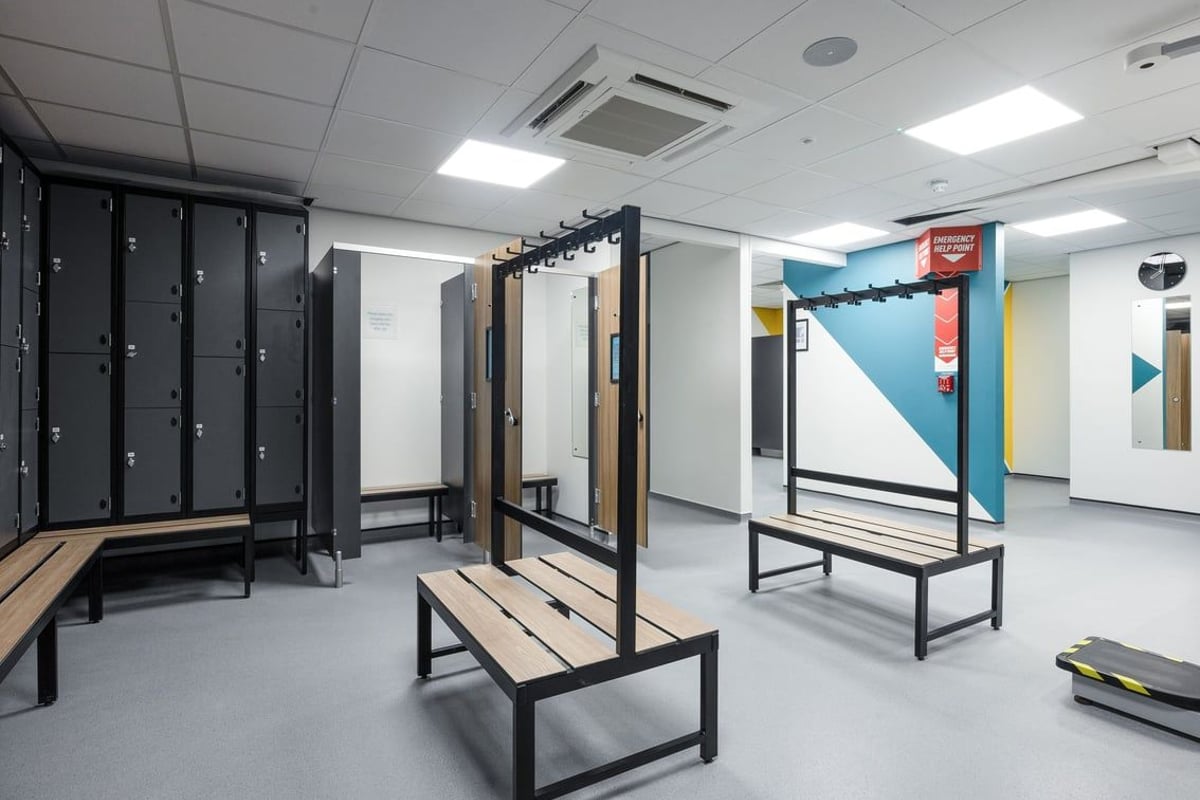 PureGym Falkirk: Locker rows, benches, mirrors, and open plan layout - typical of a gym changing area.