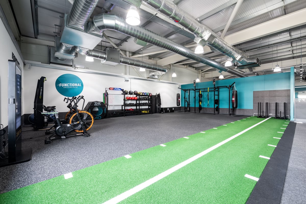 PureGym Portsmouth North Harbour: Gym studio with resistance machines, green turf area, free weights, and workout rigs.