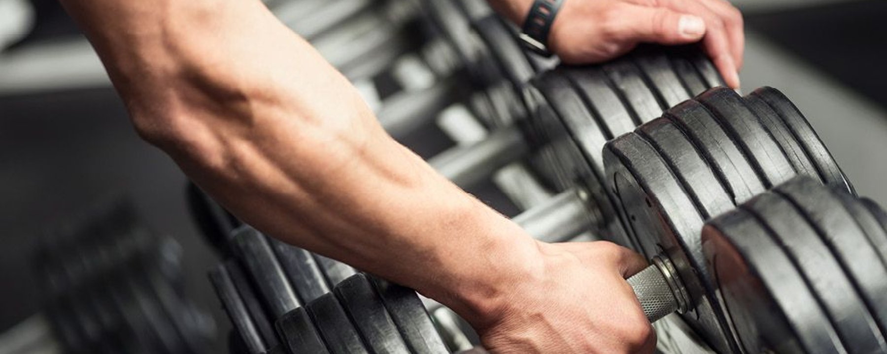Arm picking up dumbbell