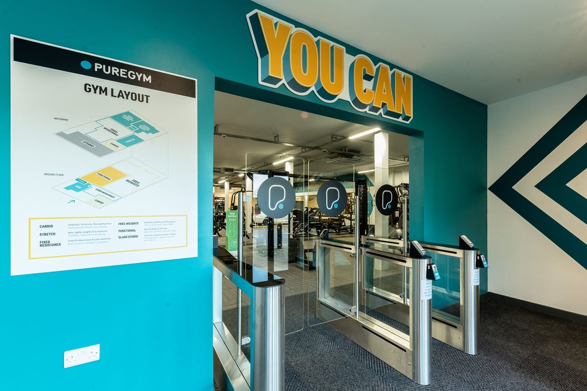 PureGym Boston: Glass entrance doors with signage, exercise equipment visible inside.