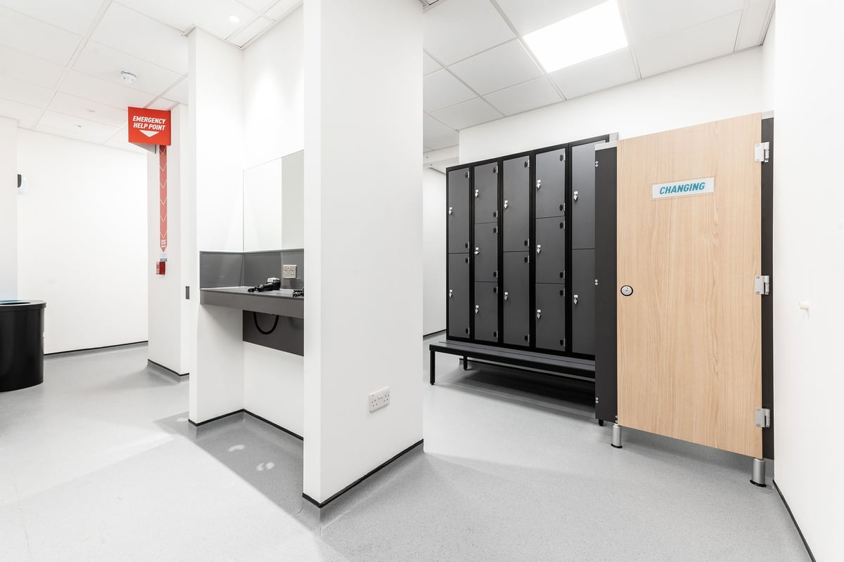 PureGym London Monument: Changing rooms with lockers, bench, and minimalist design.