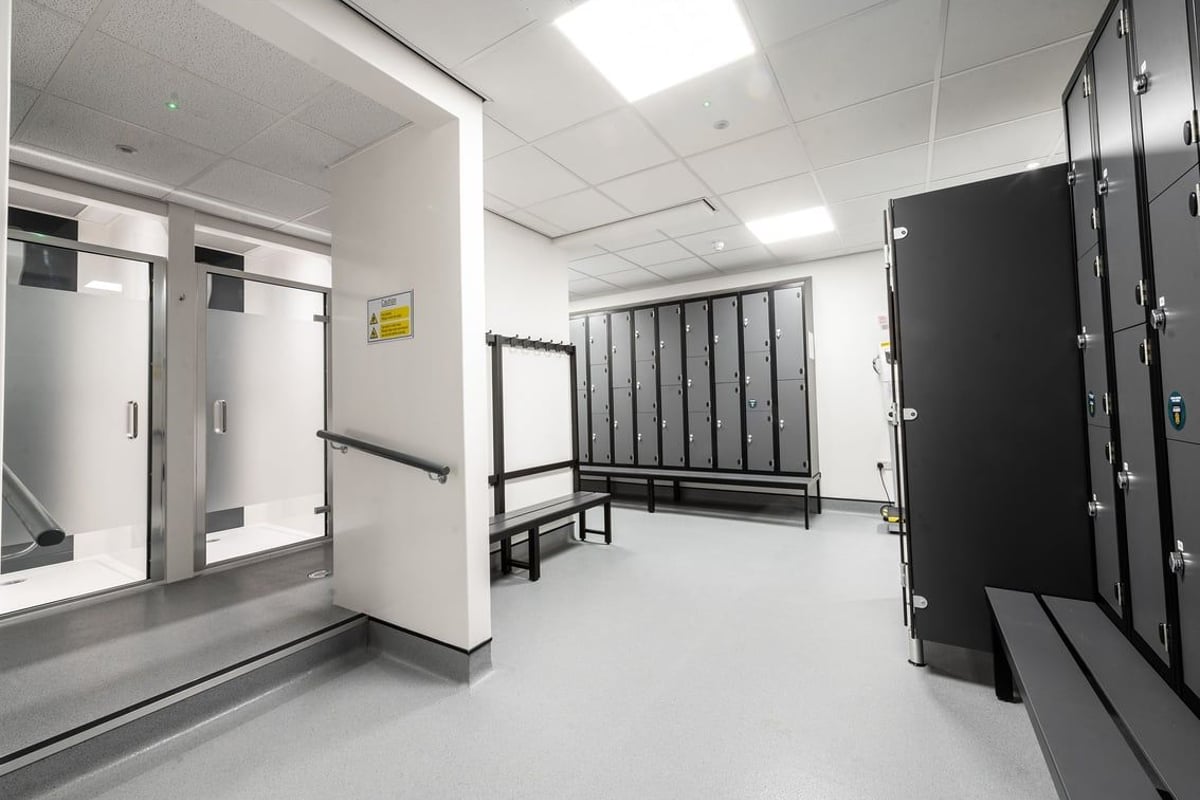 PureGym Trowbridge: Lockers, benches, and equipment storage in a changing room area.