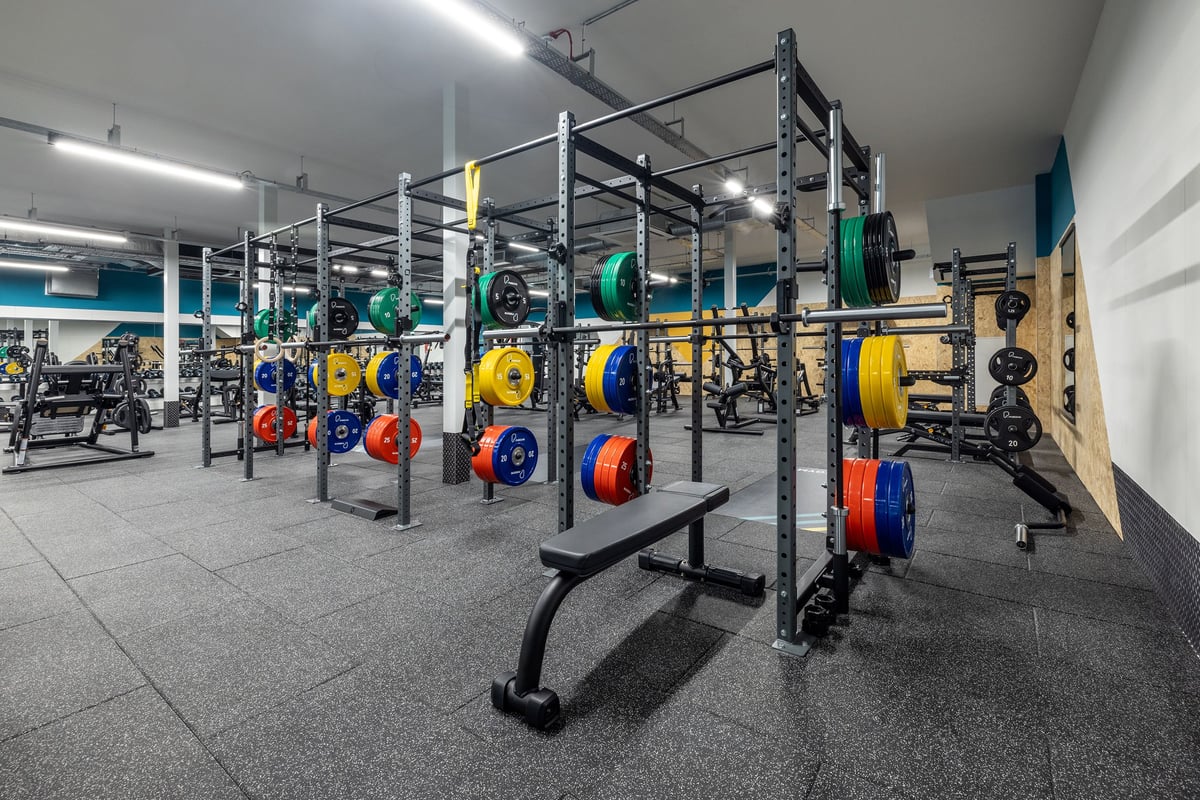 PureGym Hull Clough Road: Weight racks, colourful bumper plates, benches, and rubberized flooring in a gym/fitness studio.