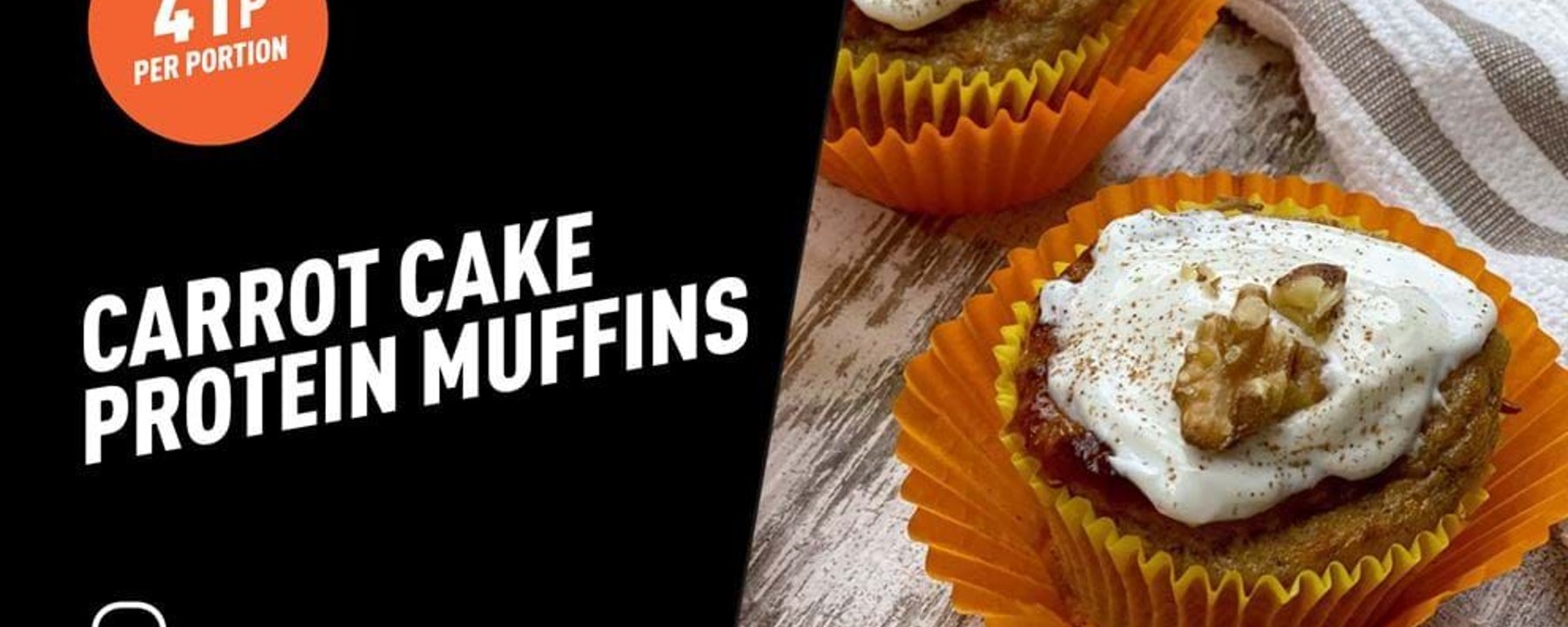 Carrot cake protein muffins with cream cheese frosting and walnut halves in orange cases