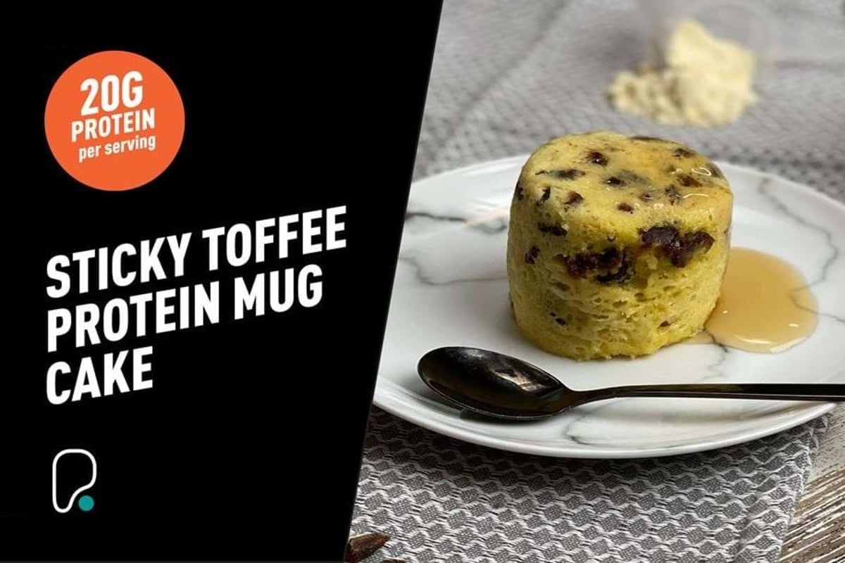 Golden sponge cake with chocolate chips and toffee sauce on a white plate with a spoon