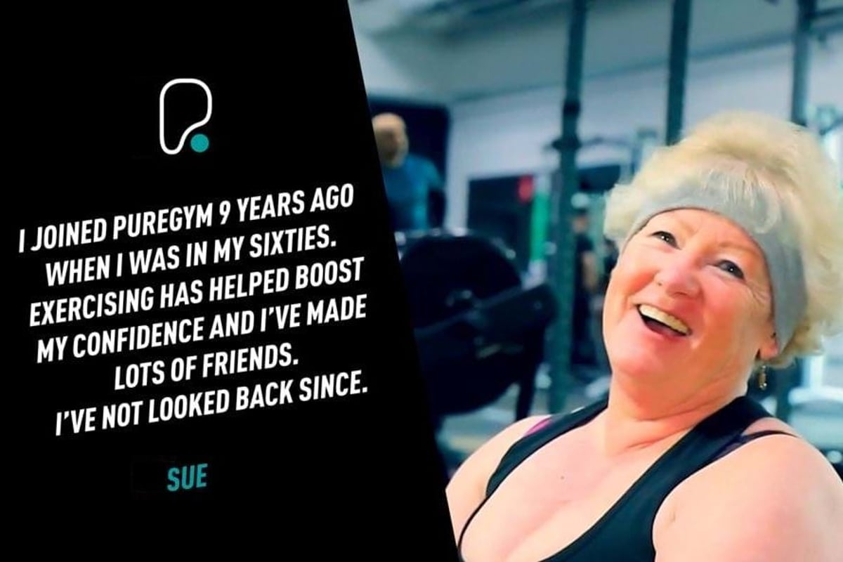 Smiling elderly woman wearing a headband and gym clothes in a fitness centre.