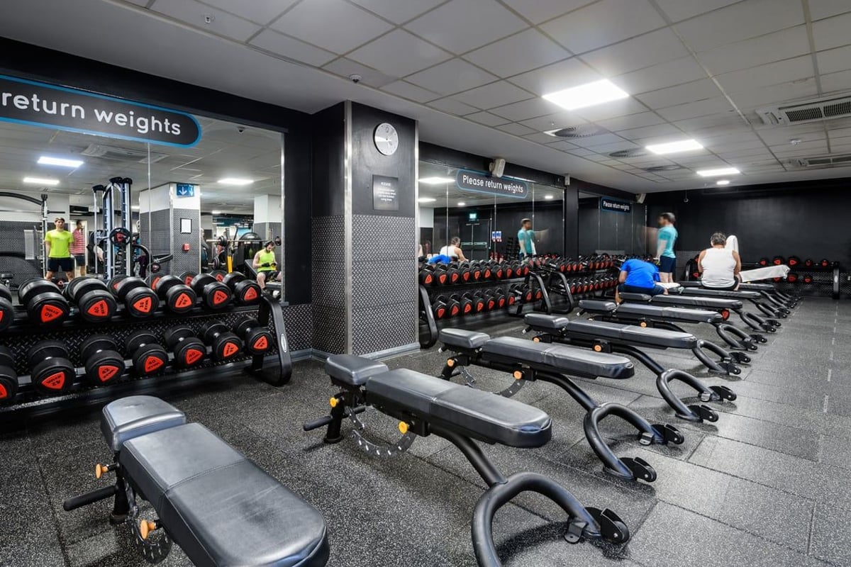 PureGym London Moorgate: Free weights, benches, racks and rubberized flooring in a gym setting.