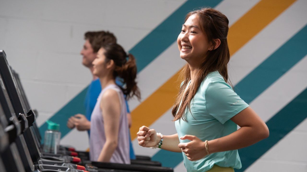 Female gym goer running on a treadmill