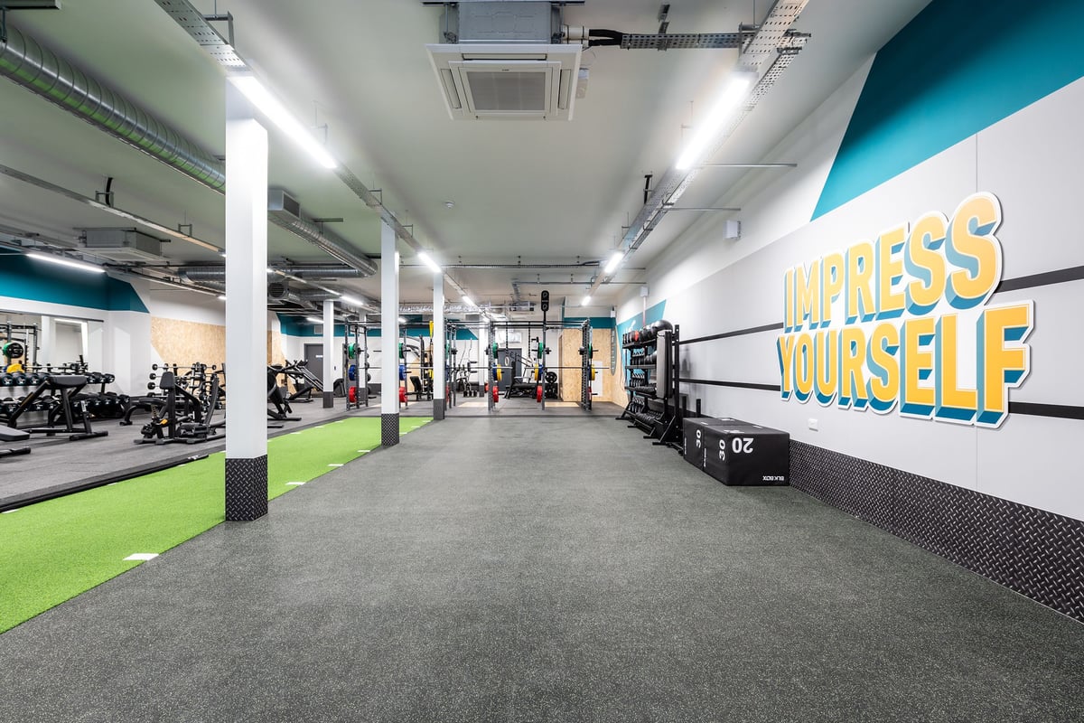 PureGym Guiseley: Resistance machines, free weights, cable crossovers, rubberized flooring in a brightly lit space.