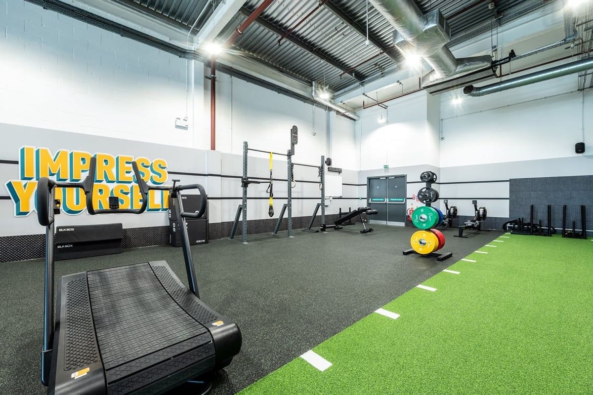PureGym Newport Wales: Treadmills, squat racks, free weights, and turf area for functional training.