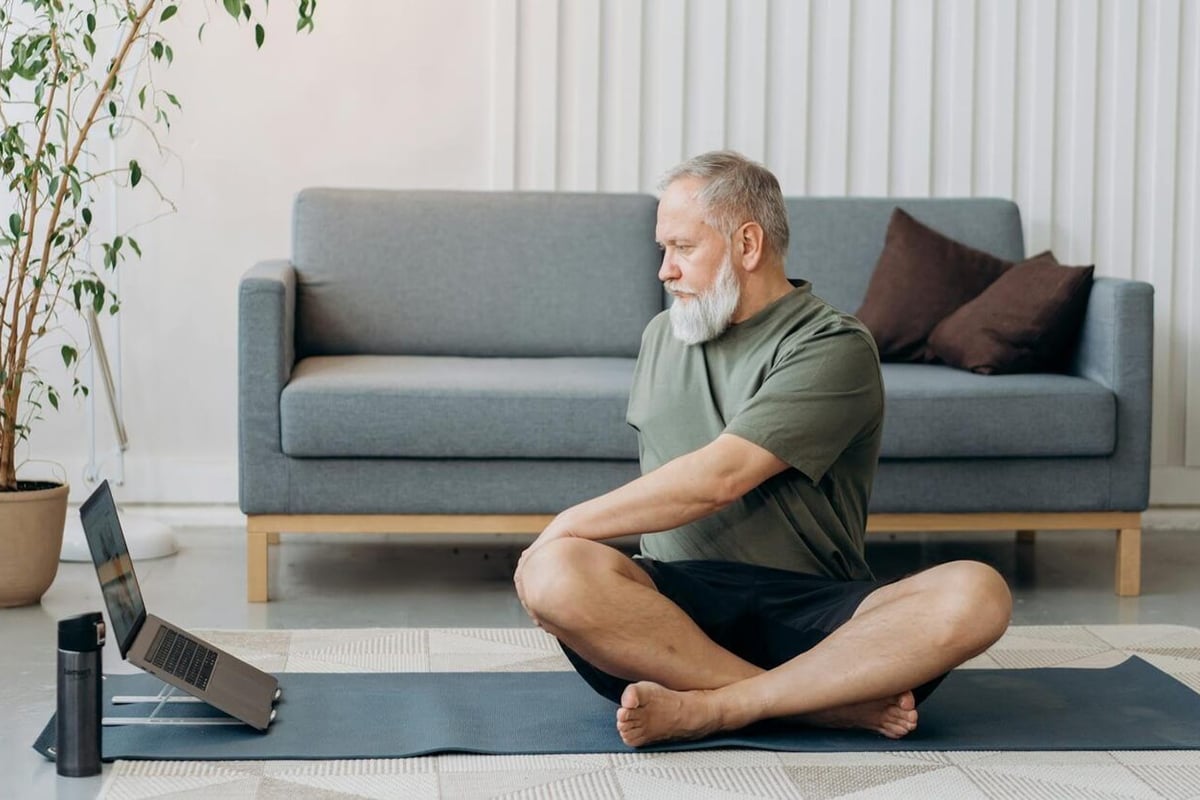 Man doing home workout on a yoga mat