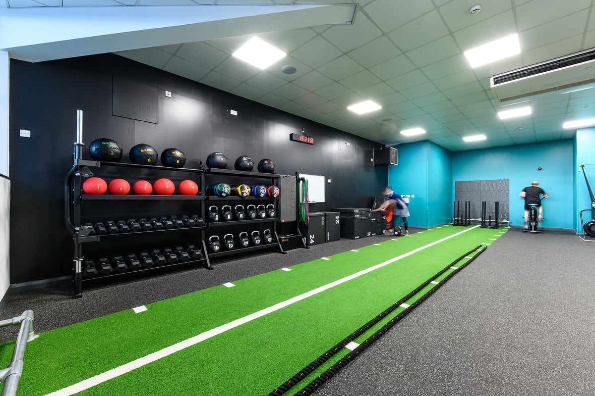 PureGym Mansfield: Gym studio with weight racks, medicine balls, turf area, and mirrored walls for functional training.