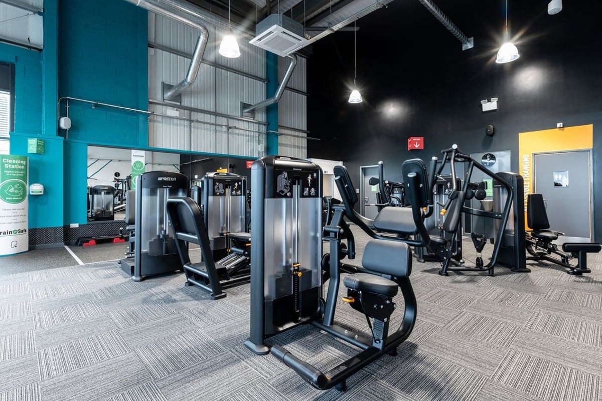 PureGym Birmingham Longbridge: Resistance machines, cable machines, free weights, and rubberized flooring in a gym setting.
