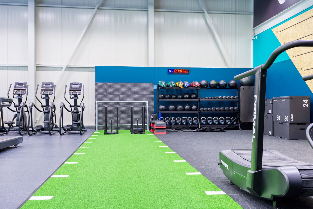 Gym Oftringen functional area with turf track, sleds, kettlebells and slam balls