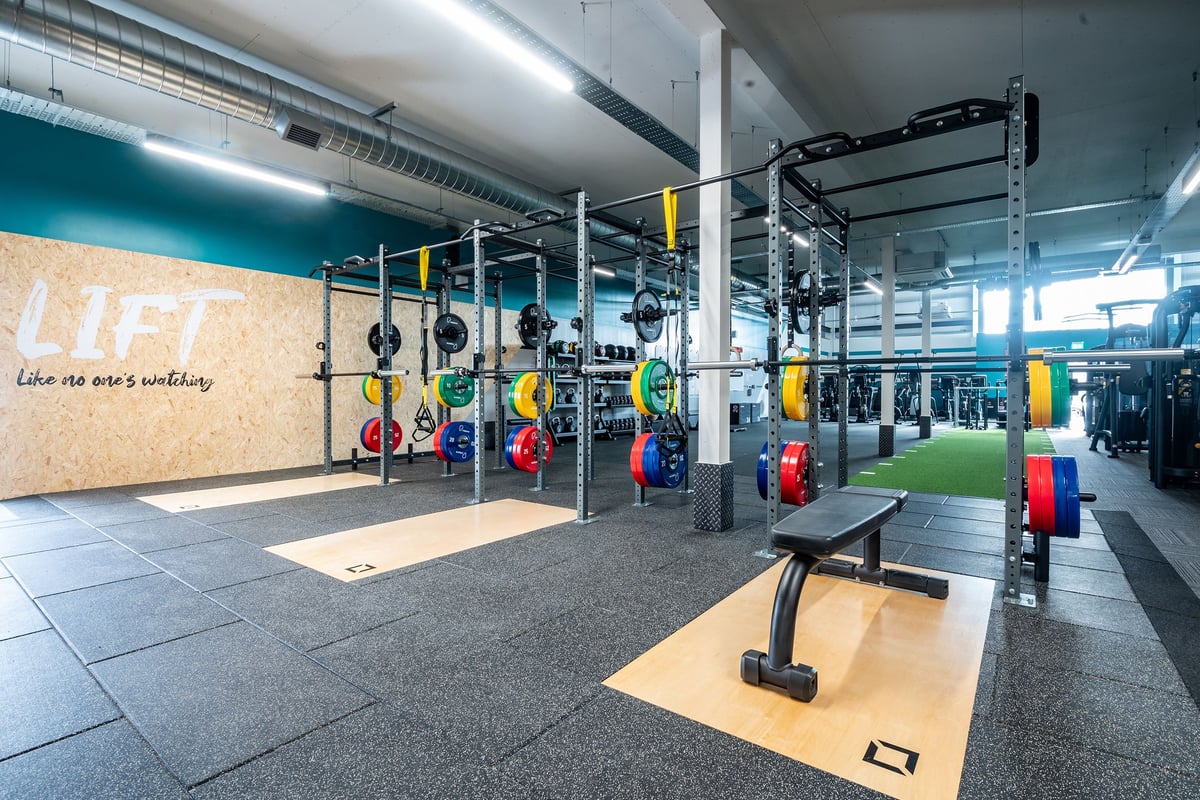 PureGym Glasgow Rutherglen: Functional training area with rig, weight plates, turf, benches, and weight storage racks.