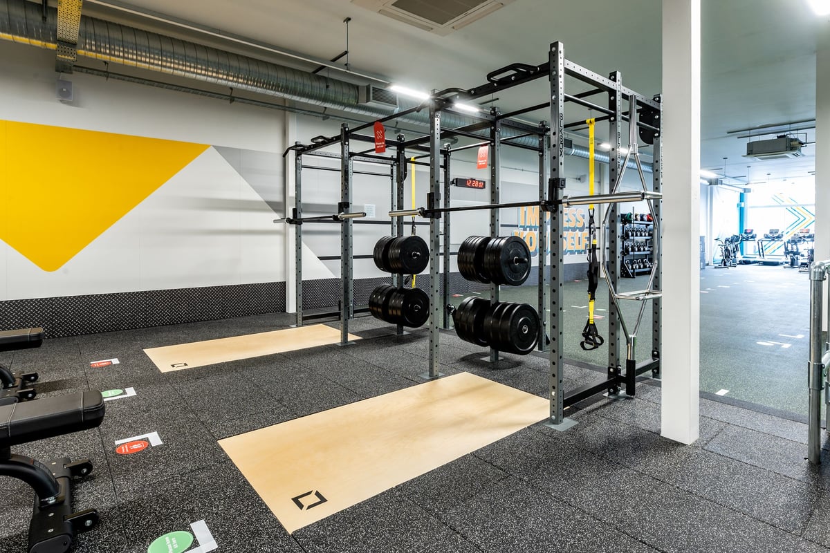 PureGym Bournemouth Mallard Road Retail Park: Squat racks, weight plates, platforms, rubberized flooring, and accent walls.