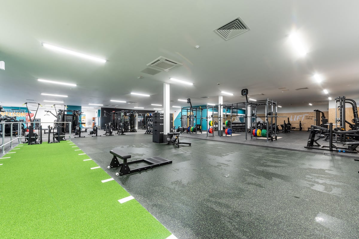 PureGym Knaesborough: Racks, benches, weights, turf area, and rubberized flooring of a well-equipped gym space.