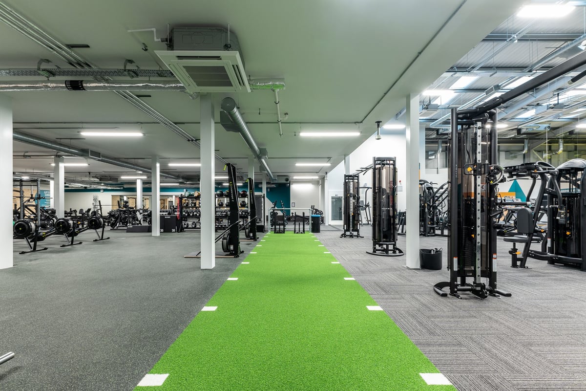 PureGym Broadstairs Westwood Gateway Retail Park: Rows of weightlifting machines, green turf track, and exercise equipment.