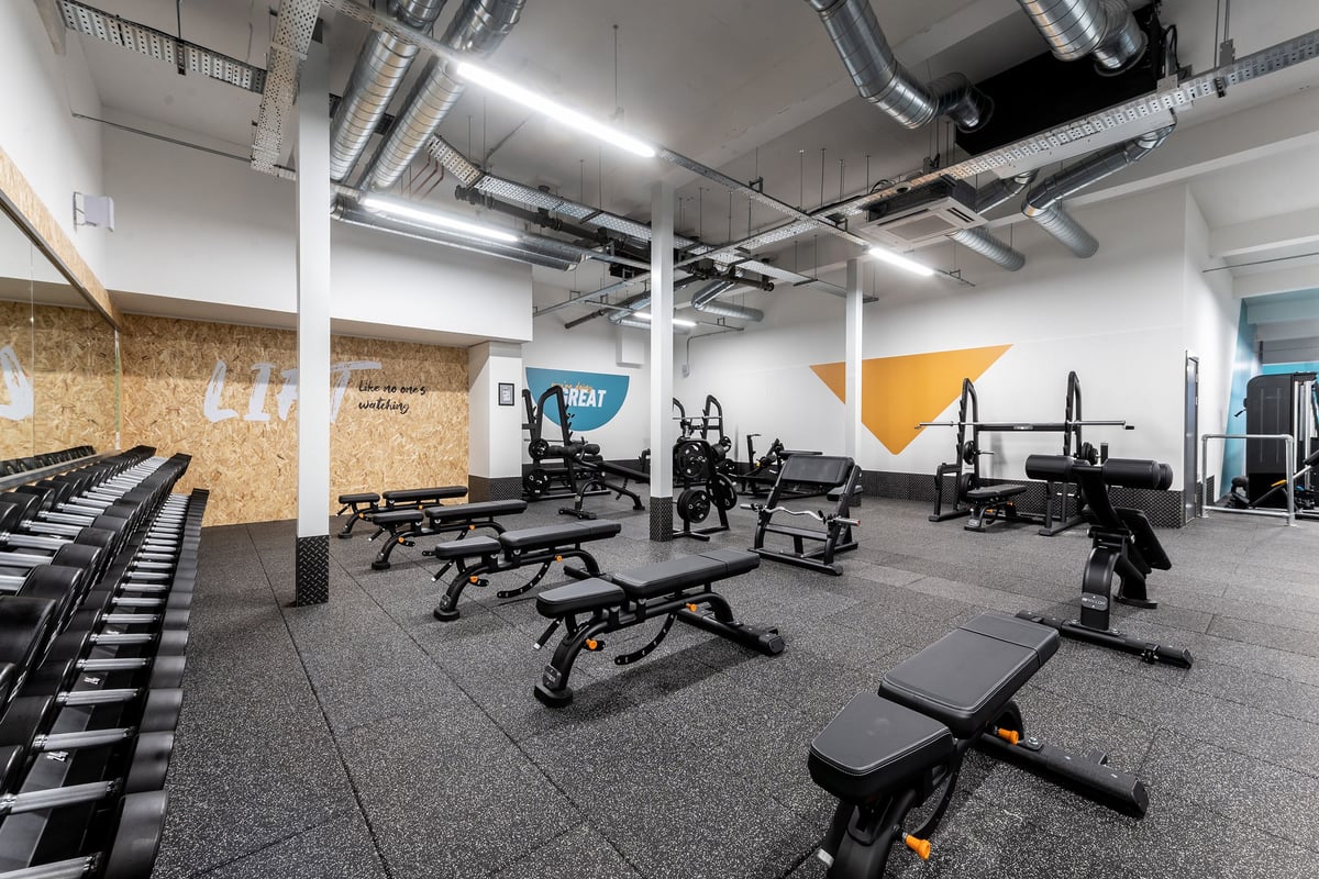 PureGym Edinburgh Craigleith Retail Park: Weight benches, resistance machines, rubberized flooring in a modern gym facility.