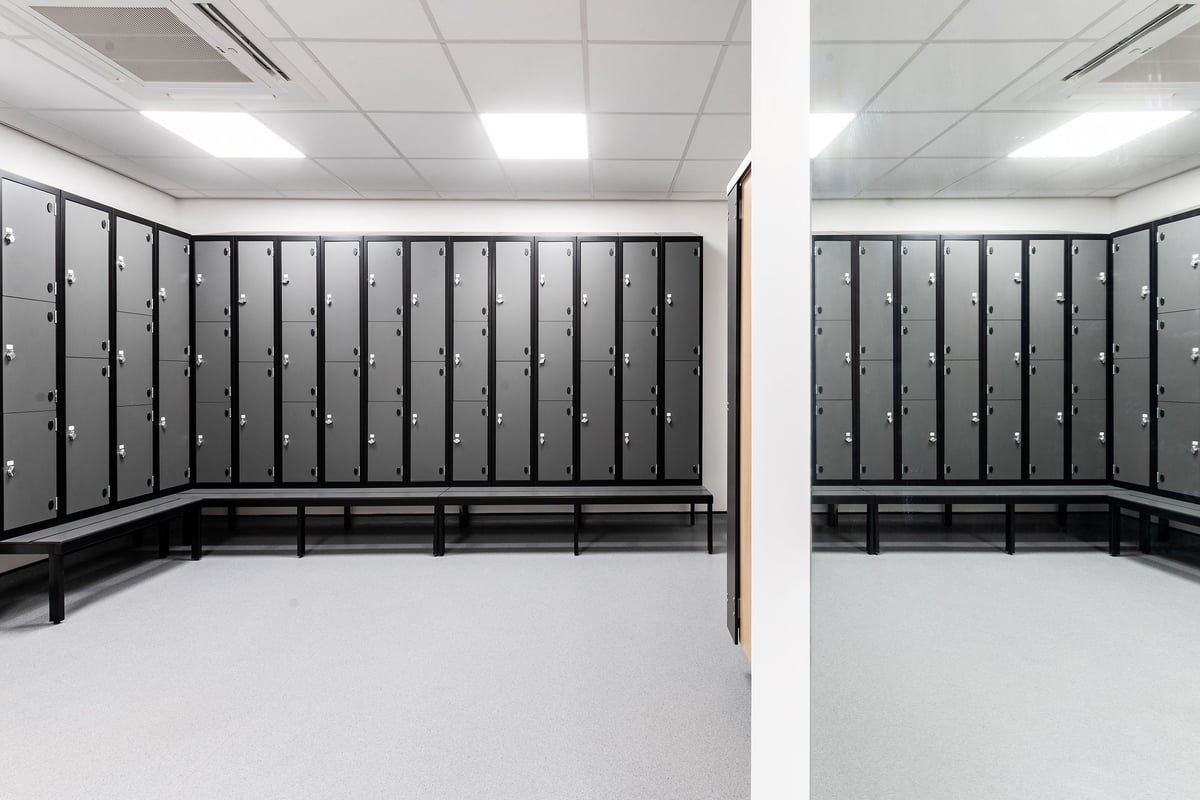 PureGym London Holloway Road: Rows of lockers and benches lined up in a changing room setting.