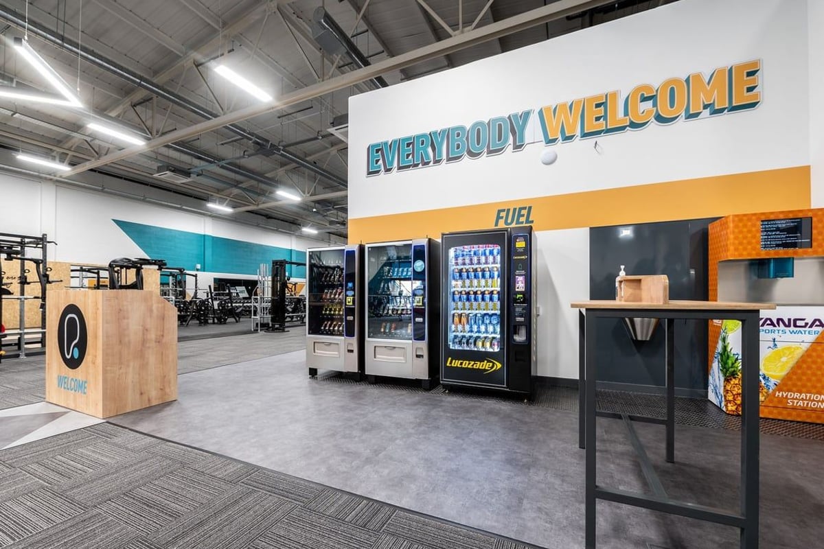 PureGym Taunton: Vending machines, welcome sign, and what appears to be a gym reception area.
