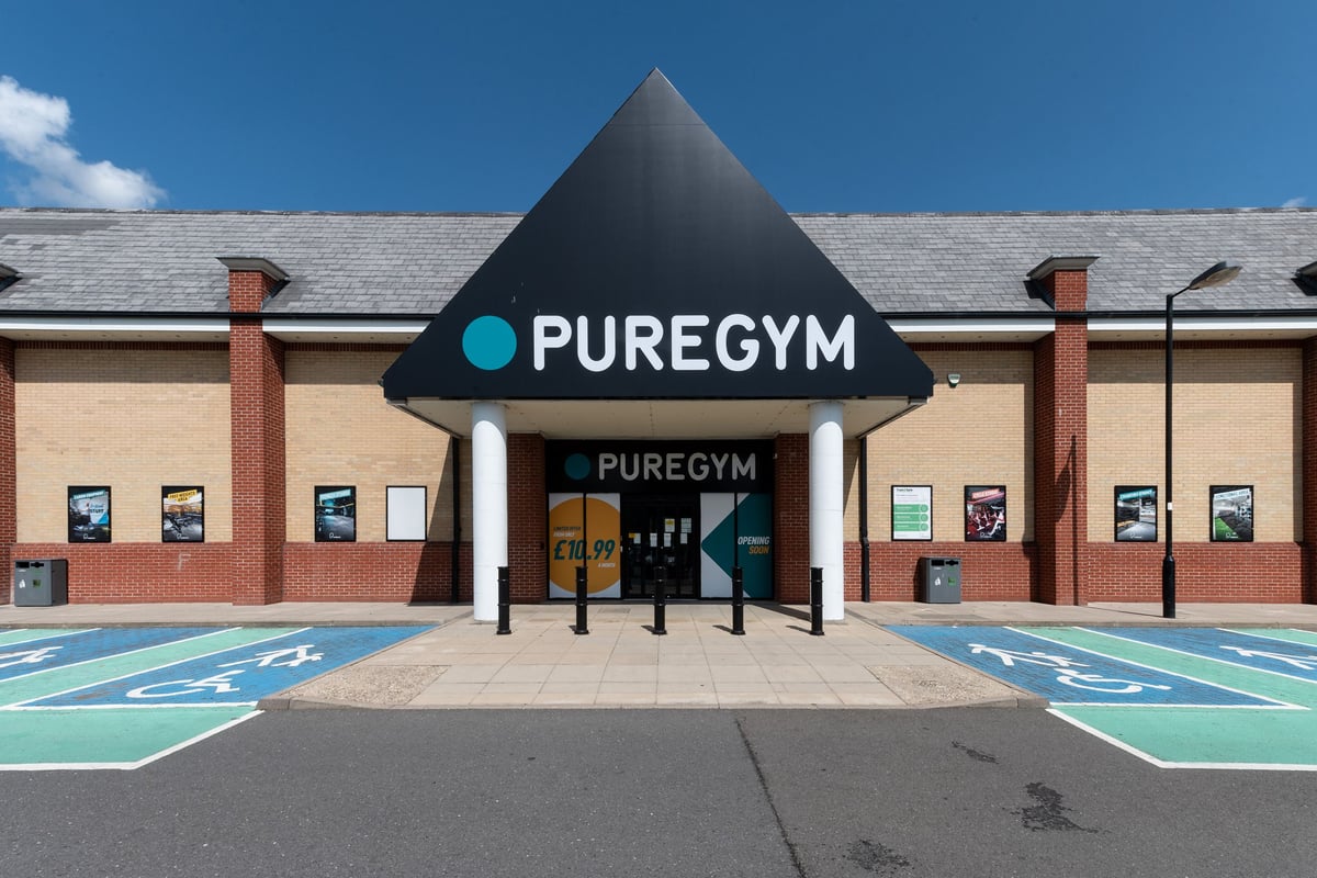 PureGym Colchester Retail Park: Gym exterior with signage, parking spaces, and entrance.