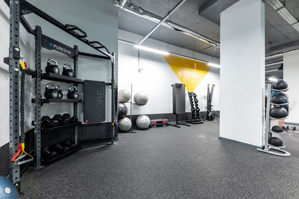 PureGym London Hammersmith Palais: Strength training racks, medicine balls, free weights, rubberized floors in a gym studio.