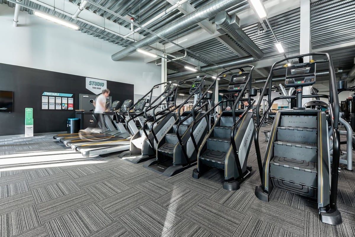 PureGym Hednesford Cannock: Rows of treadmills, ellipticals, and exercise bikes inside a fitness centre.