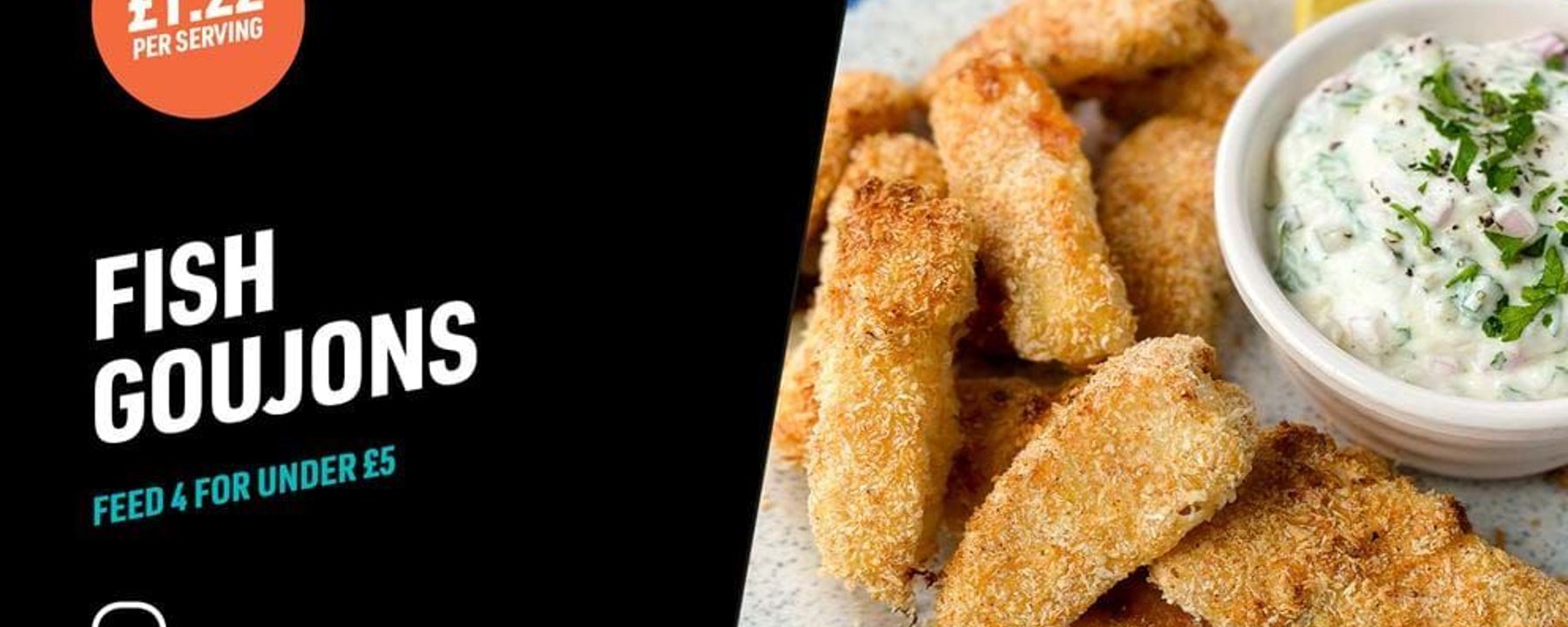 Breaded fish goujons on a plate with a bowl of creamy herb dip and lemon wedge