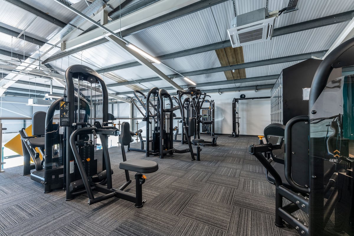 PureGym Crewe Grand Junction Retail Park: Weight machines, resistance equipment, rubberized flooring in a bright gym space.