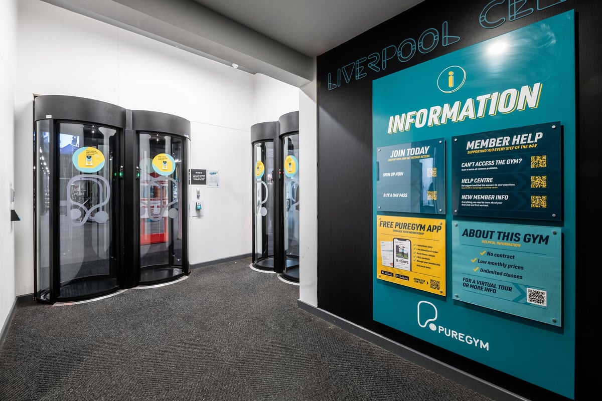PureGym Liverpool Central: Entry pods and wall postings about the gym, member help, how to join, and the mobile app.