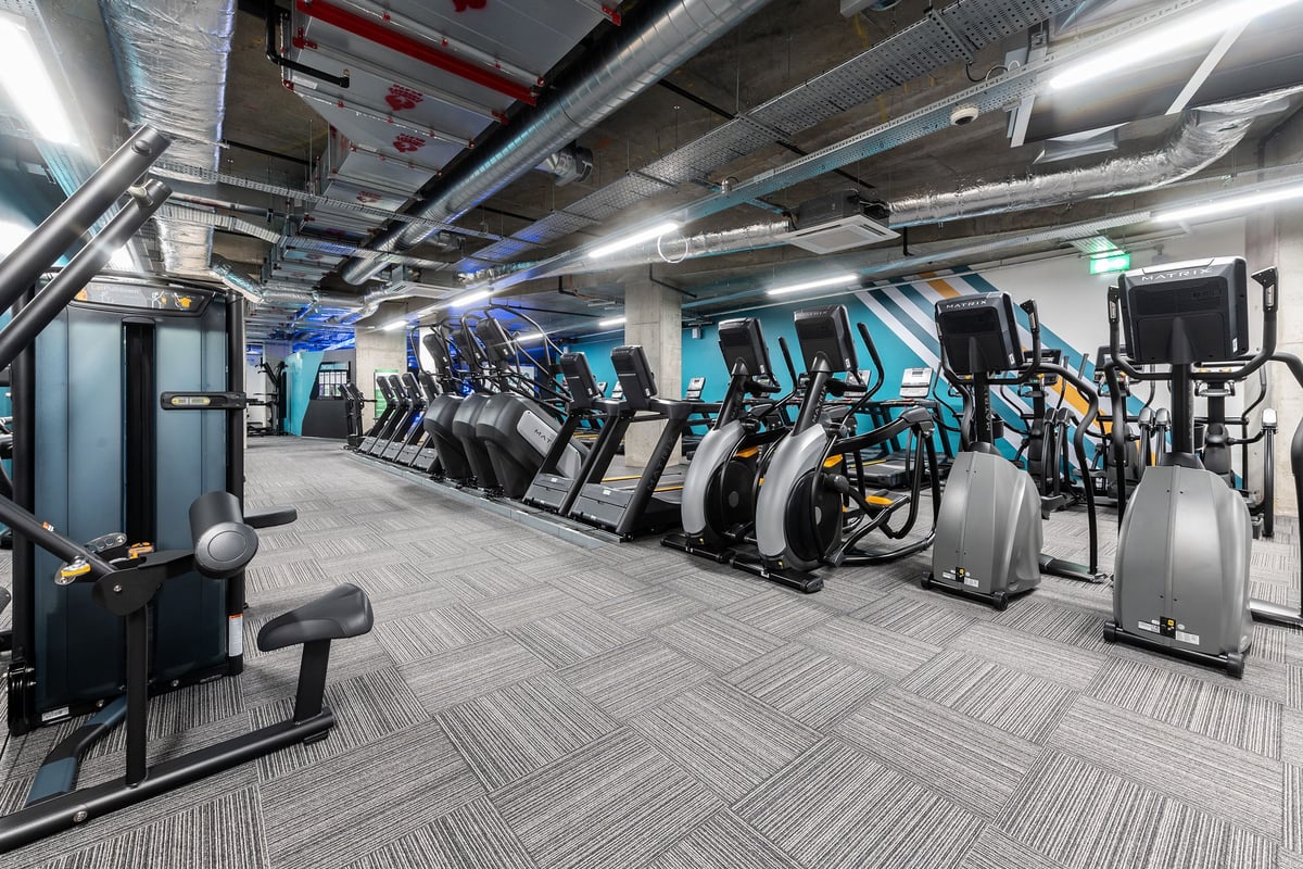 PureGym London Hoxton: Rows of cardio machines like ellipticals and treadmills in a modern gym studio.