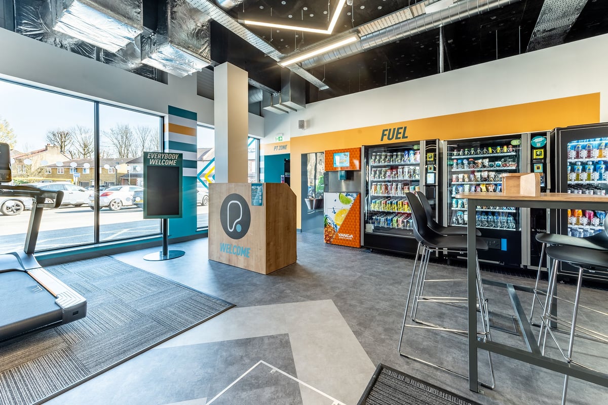 PureGym London Beckenham: Vending machines, staff kiosk, seating area near the gym entrance.