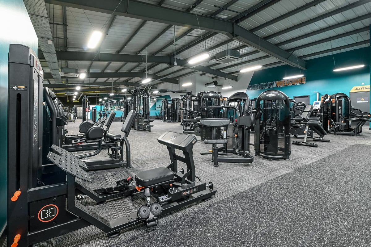 PureGym Canterbury Sturry Road: Rows of weight machines, strength equipment, and rubberized flooring in a large gym facility.