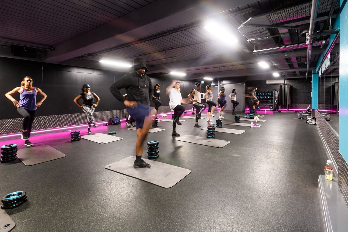 PureGym London Lambeth: Aerobic studio with step benches, free weights, and mirrored wall.