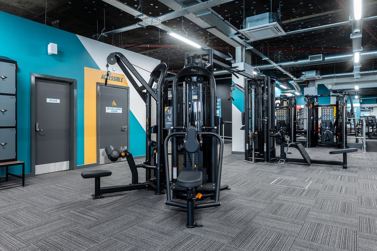 PureGym London Beckenham: Weight machines, cable crossovers, Smith machines, benches, turf flooring in a modern gym setting.