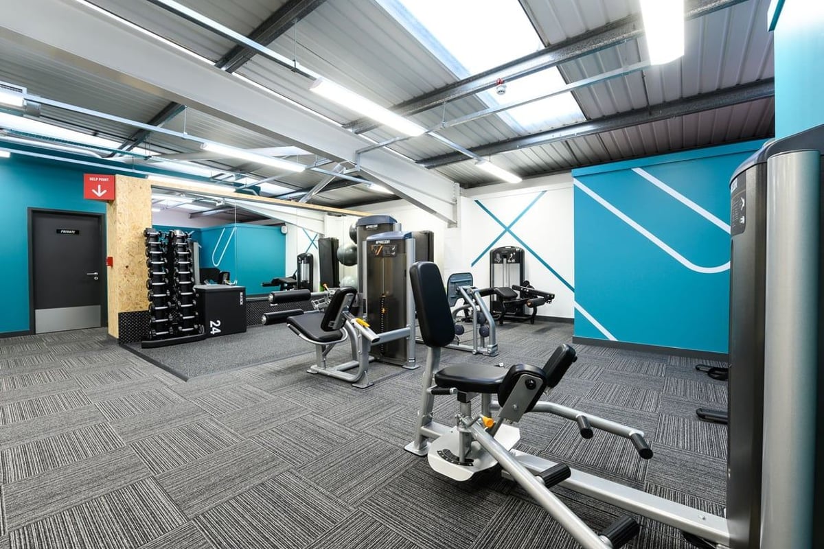 PureGym Rayleigh: Weight machines, resistance bands, exercise balls, rubberized flooring in a gym studio.
