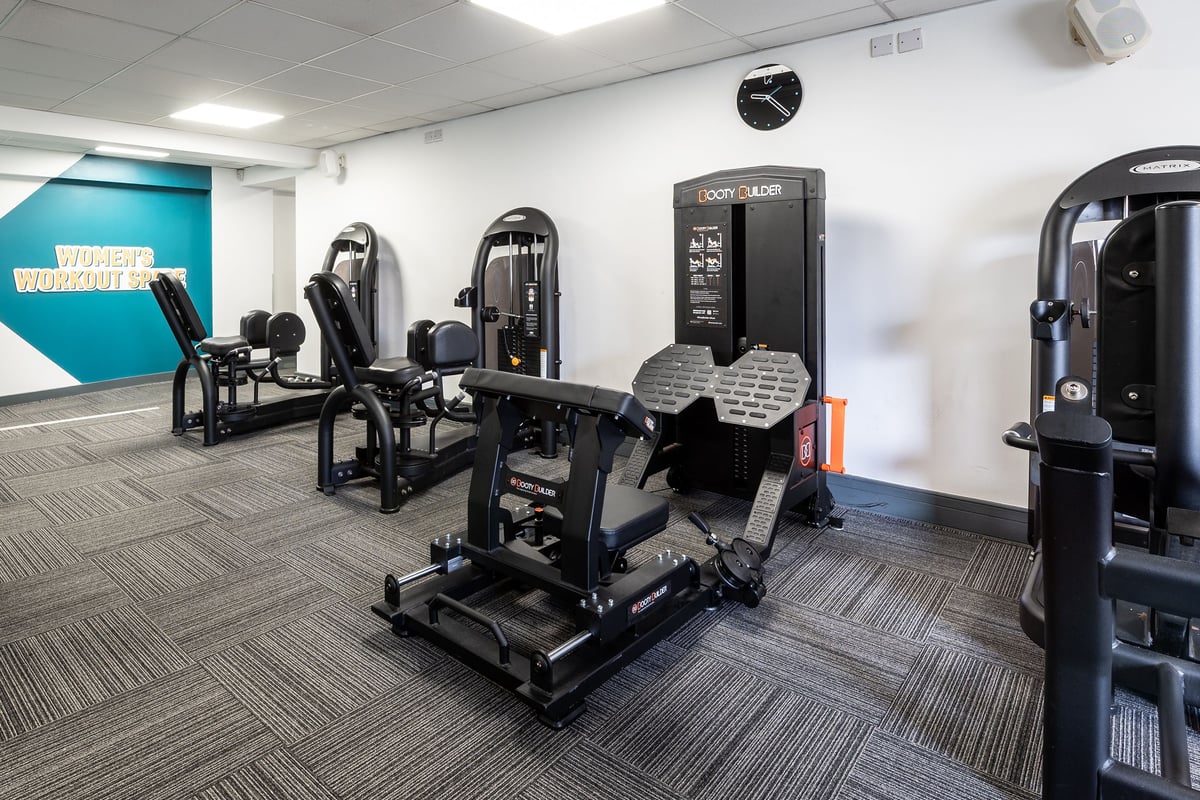 PureGym Sutton Coldfield: Resistance machines, free weights, mirrors, and rubberized flooring in a fitness studio.