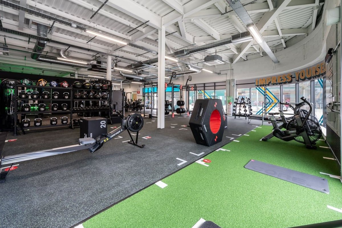 PureGym Aldershot Westgate Retail Park: Gym with weight racks, sleds, turf area, free weights, and rubberized flooring.