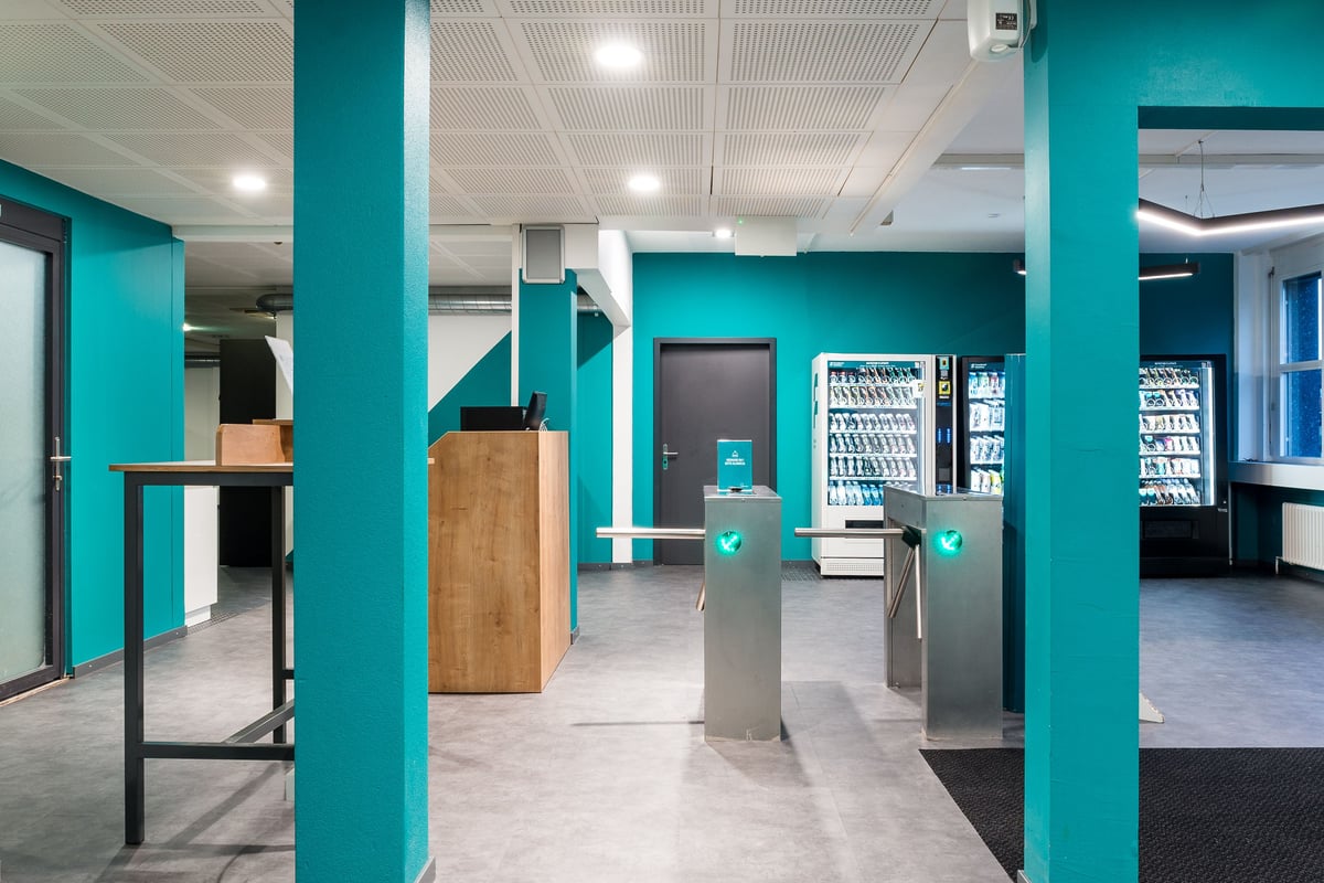 Entrée de la gym Lochergut avec portiques, accueil et distributeurs automatiques