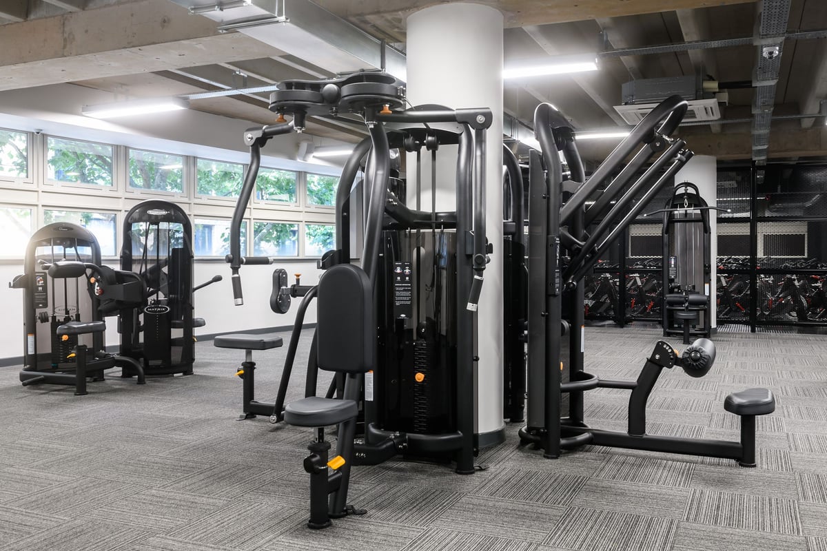 PureGym Birmingham Arcadian Centre: Weight machines, free weights, benches, and rubberized flooring in a gym setting.
