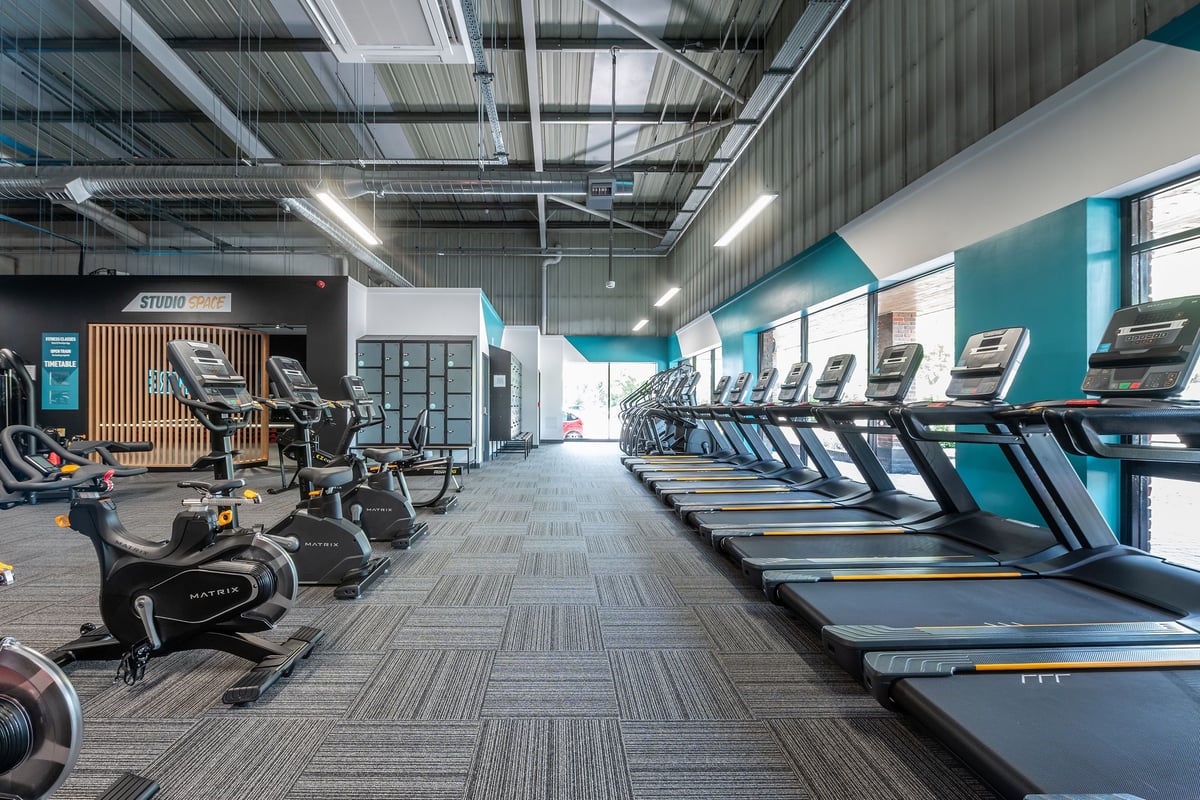 PureGym Horsham: Rows of treadmills, ellipticals, exercise bikes, and strength equipment in a modern gym interior.