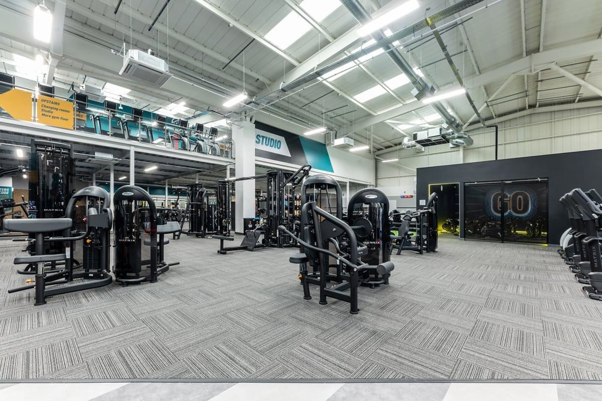 PureGym Eastbourne: Resistance machines, free weights, benches, and rubberized flooring in a gym studio.