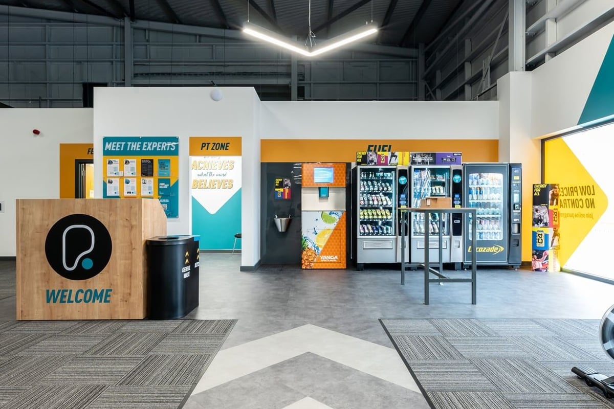 PureGym Ipswich Ravenswood: Vending machines, snacks, beverages, welcome sign, and meet-the-experts zone.