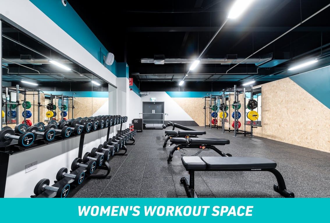 PureGym Bradford Thornbury: Women's workout space - benches and freeweights in a gym